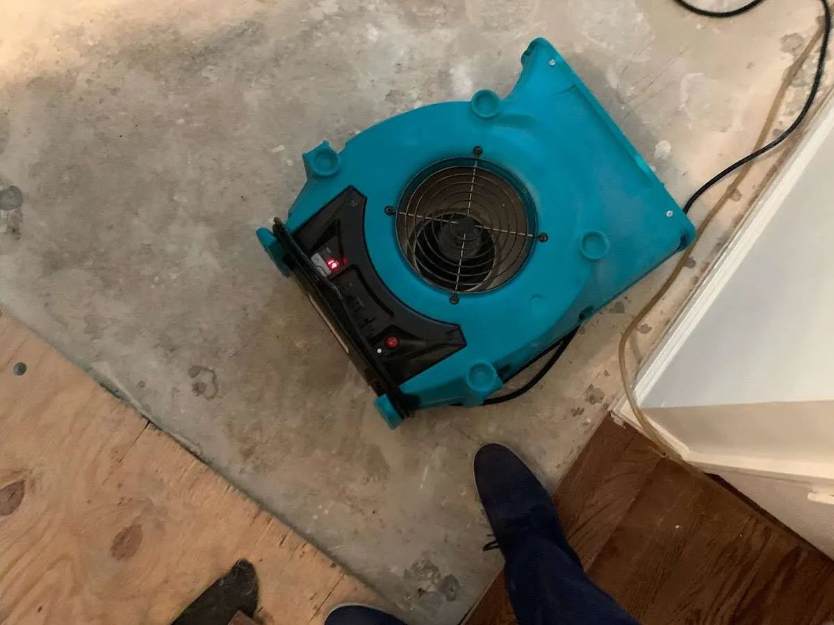 Air mover drying subfloor during Commercial Water Damage Restoration in Lake Bluff